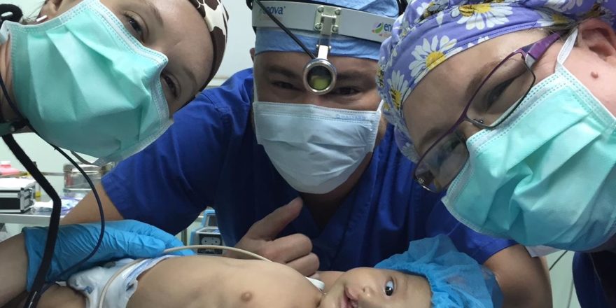 Dr. Charlie Finn | Enova Illumination Surgical LED Headlight with pediatric patient